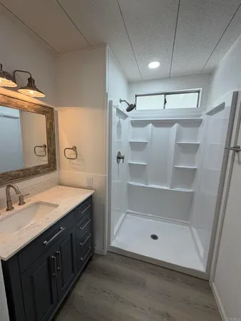 a view of a bathroom with sink mirror and window