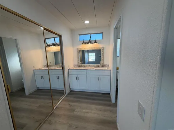 a view of walk in closet with empty racks