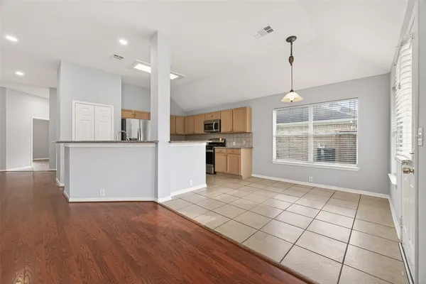 a view of a kitchen with microwave and windows
