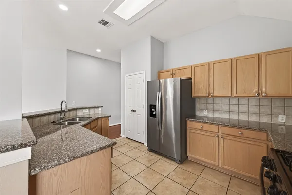 a kitchen with stainless steel appliances granite countertop a sink and cabinets
