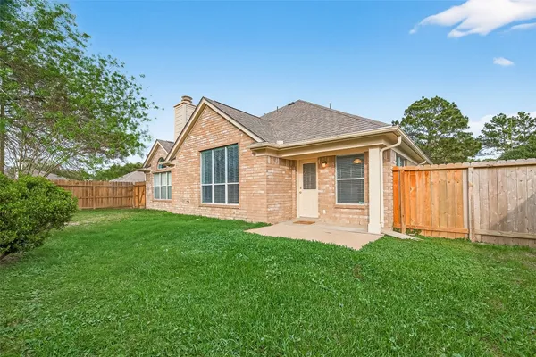 a front view of a house with a garden and yard