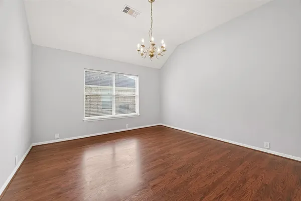 a view of wooden floor and chandelier in living room
