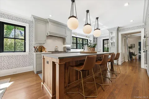 a kitchen with a dining table chairs and chandelier