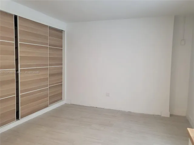 a view of an empty room and a window