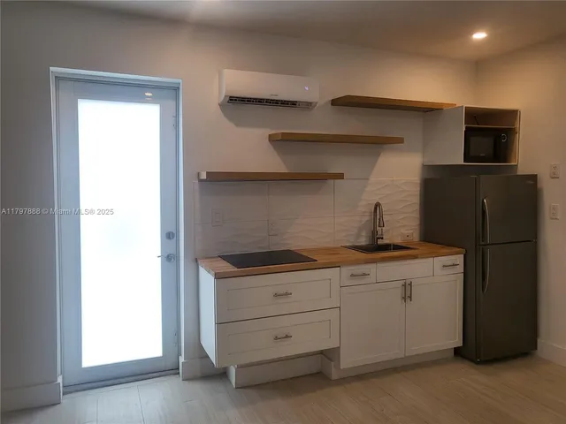 a kitchen with a stove and a refrigerator