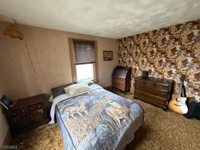 a bedroom with a bed and a chair