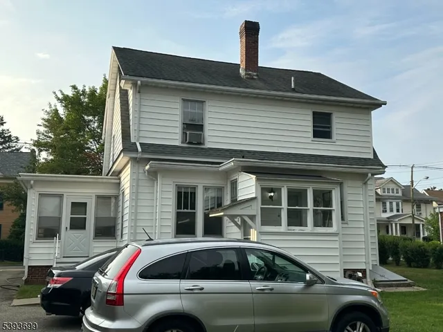 a front view of a house with parking space