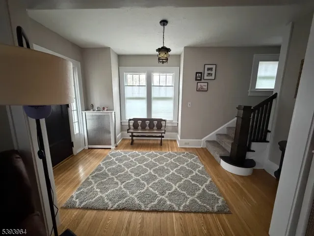 a room with wooden floor and furniture