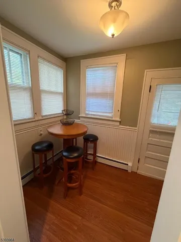 a view of a dining room with furniture and a window