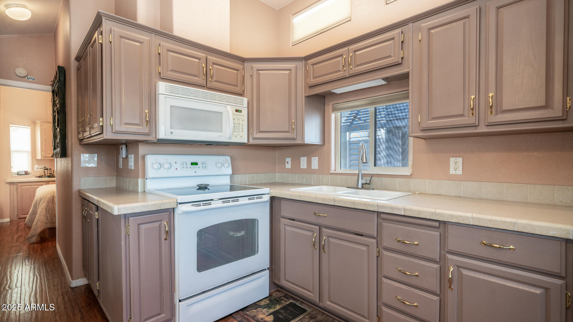 834-837 South Beryl/aquamarine Drive Apache Junction, AZ 85119 - Photo 12 of 68 a kitchen with cabinets appliances a sink and a window