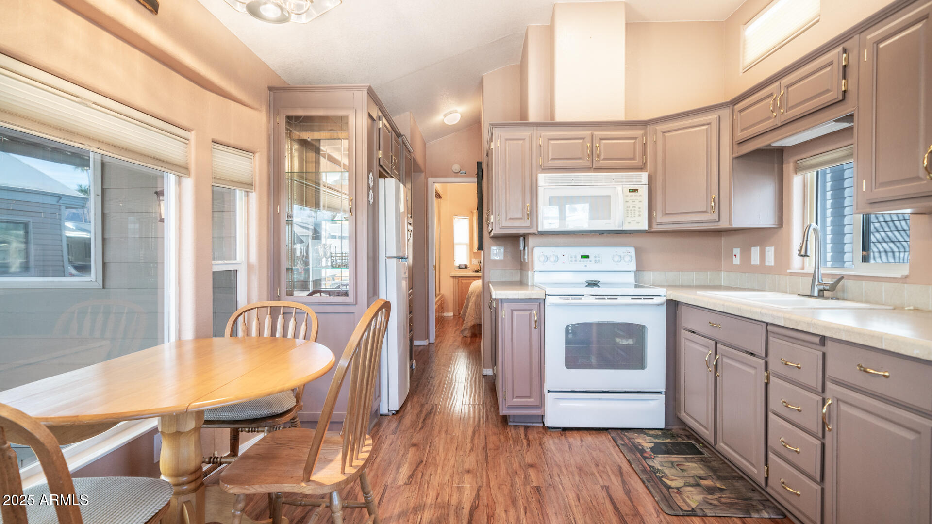 834-837 South Beryl/aquamarine Drive Apache Junction, AZ 85119 - Photo 10 of 68 a kitchen with stainless steel appliances a stove a sink dishwasher a microwave oven and a dining table with wooden floor