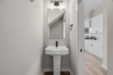a view of a hallway with wooden floor and staircase