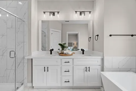 a bathroom with a double vanity sink mirror and