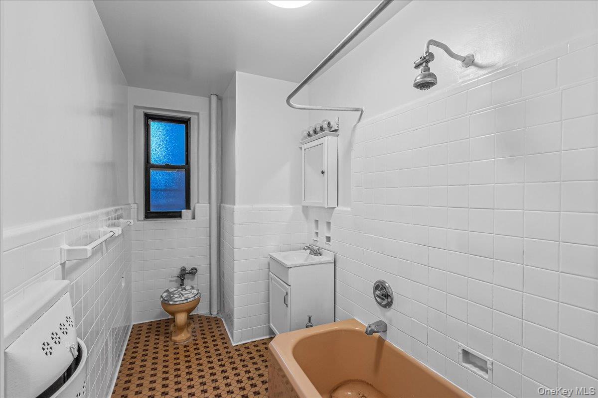 35-30 73rd Street, Unit 1F Queens, NY 11372 - Photo 14 of 24 a bathroom with a sink a toilet and shower