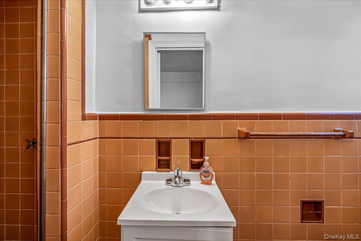 35-30 73rd Street, Unit 1F Queens, NY 11372 - Photo 18 of 24 a bathroom with a sink and a mirror