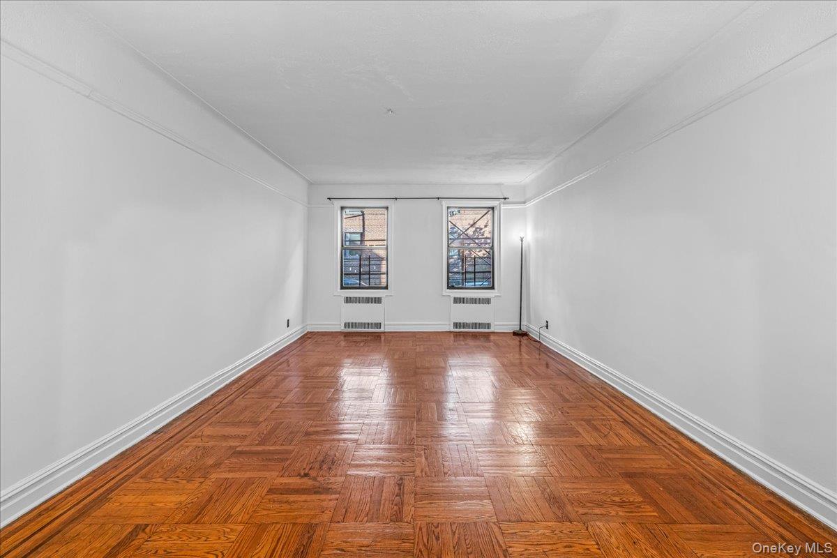 35-30 73rd Street, Unit 1F Queens, NY 11372 - Photo 2 of 24 an empty room with windows