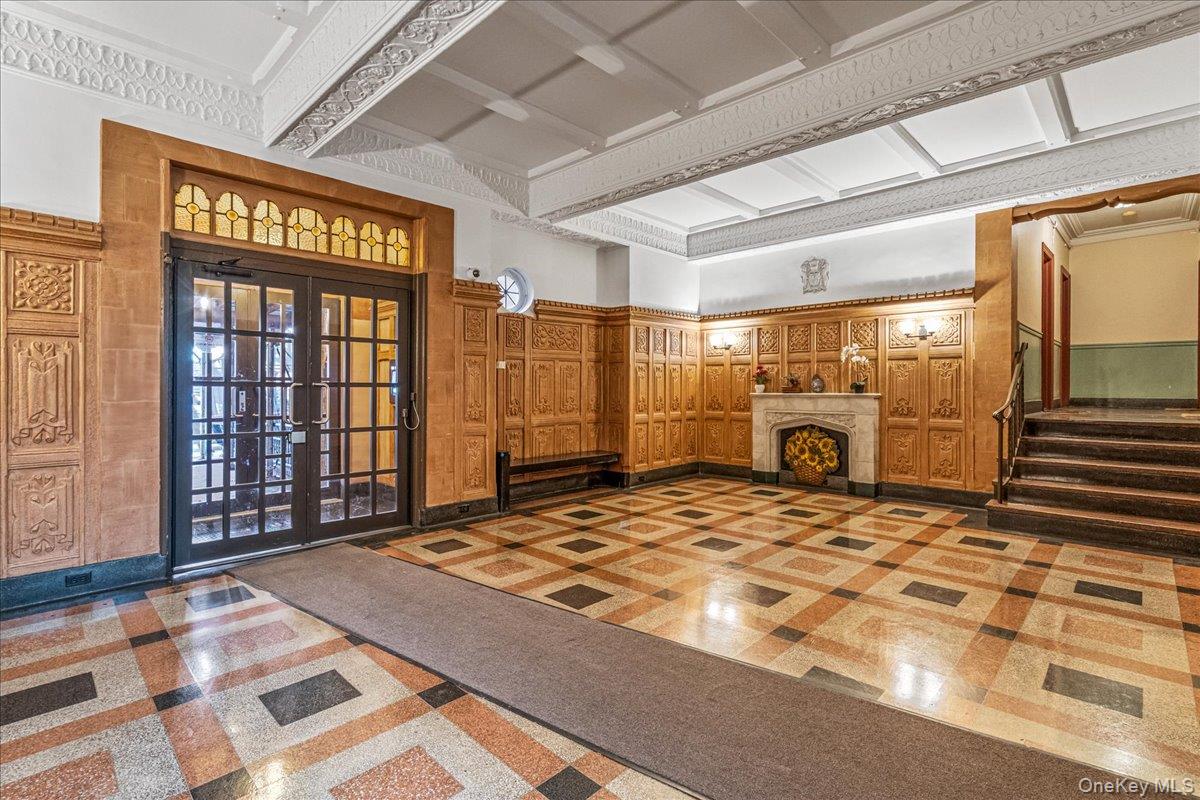 35-30 73rd Street, Unit 1F Queens, NY 11372 - Photo 21 of 24 a large bedroom with a large bed and a chandelier