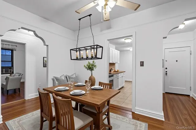 a view of a dining room with furniture wooden floor and chandelier