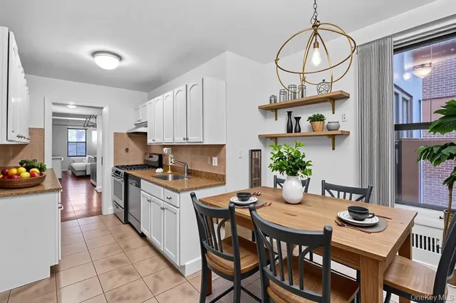 a kitchen with stainless steel appliances a stove a refrigerator and cabinets