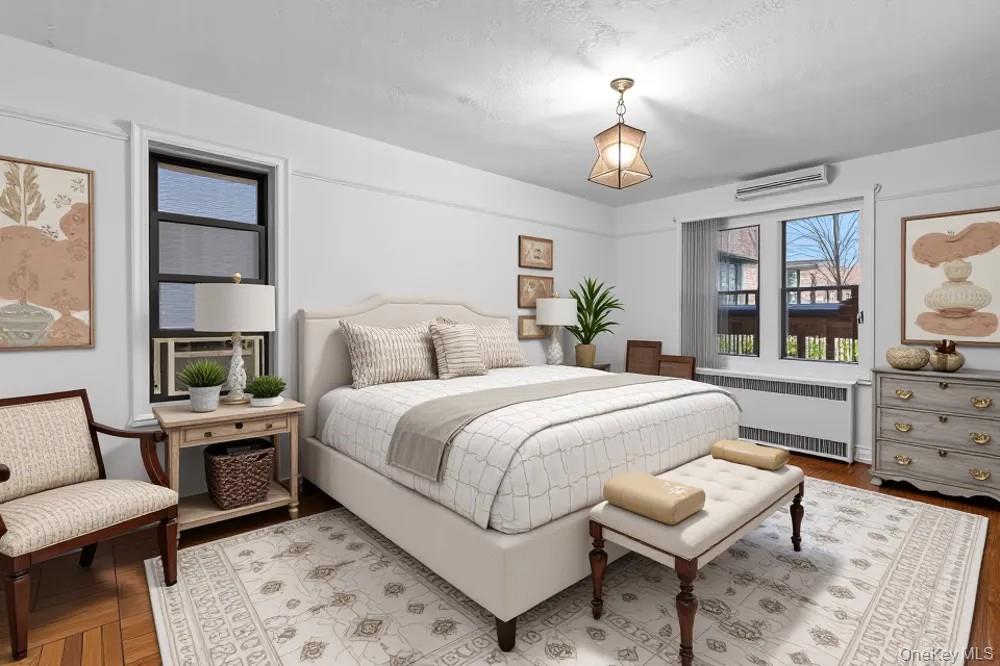 35-30 73rd Street, Unit 1F Queens, NY 11372 - Photo 7 of 24 a bedroom with a bed a dresser and next to a window