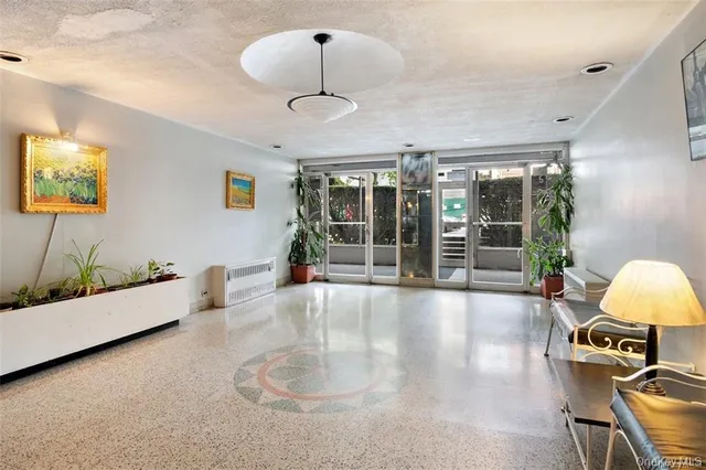 a large living room with furniture and chandelier