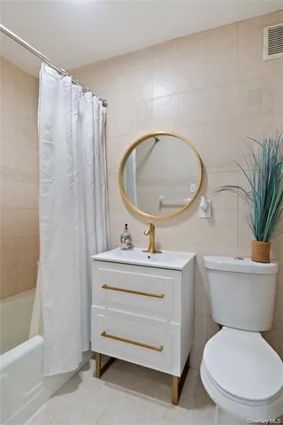a bathroom with a toilet a sink and a mirror