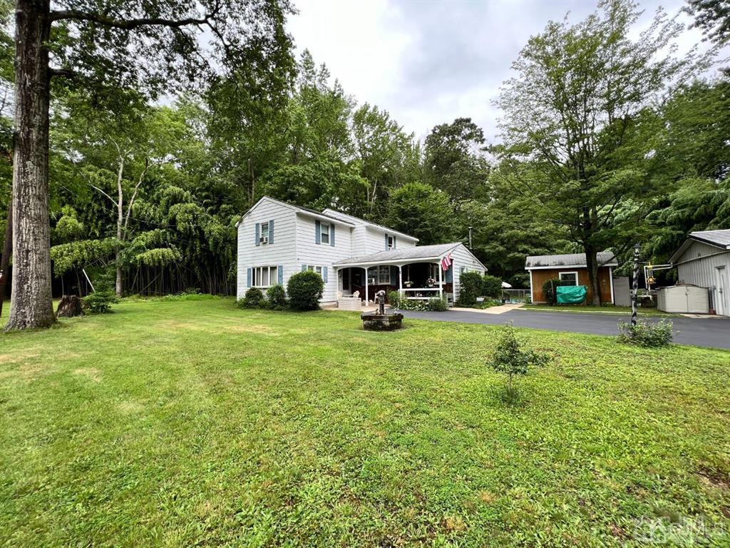 21 White Pine Road North Brunswick, NJ 08902 - Photo 1 of 33 a front view of a house with a yard and trees