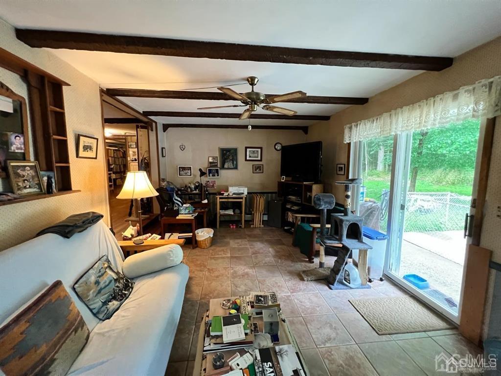 21 White Pine Road North Brunswick, NJ 08902 - Photo 13 of 33 a living room with furniture a large window and gym equipment