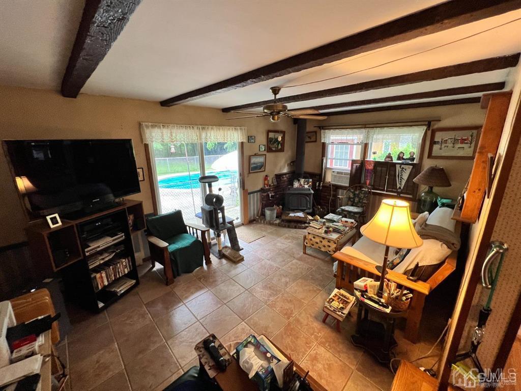 21 White Pine Road North Brunswick, NJ 08902 - Photo 14 of 33 a living room with furniture a flat screen tv and gym equipment