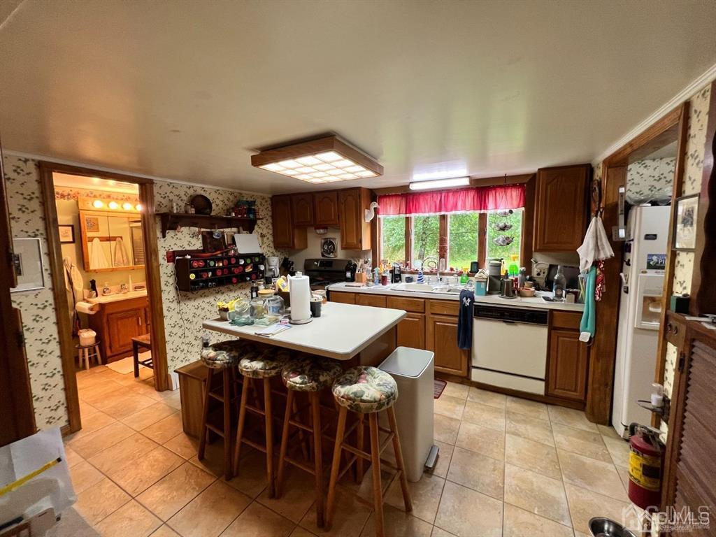 21 White Pine Road North Brunswick, NJ 08902 - Photo 15 of 33 a kitchen with stainless steel appliances granite countertop a sink a stove and a refrigerator