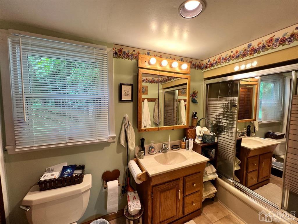 21 White Pine Road North Brunswick, NJ 08902 - Photo 19 of 33 a bathroom with a granite countertop sink and a large mirror next to a window
