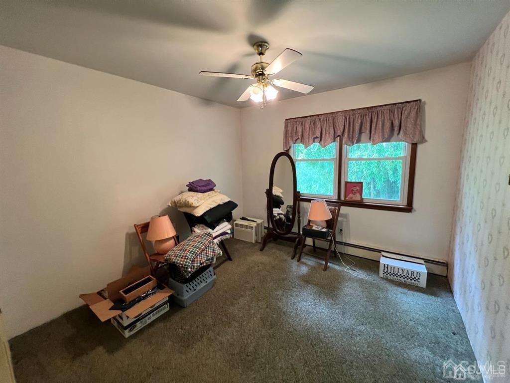 21 White Pine Road North Brunswick, NJ 08902 - Photo 23 of 33 a living room with furniture gym equipment and a chandelier