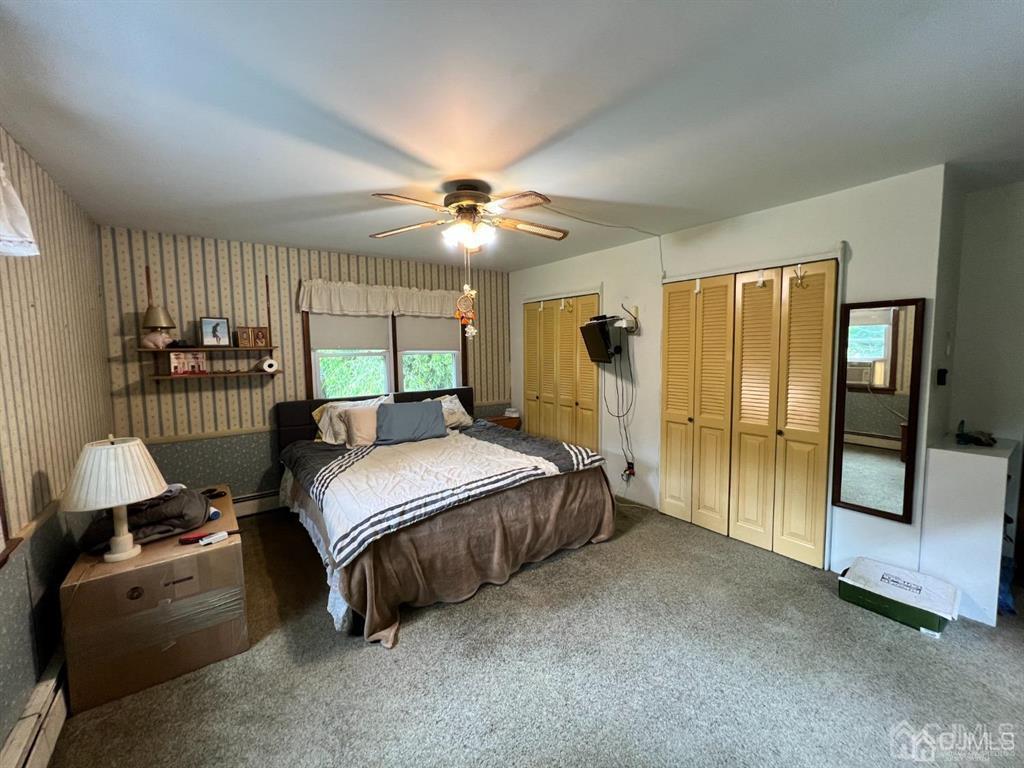 21 White Pine Road North Brunswick, NJ 08902 - Photo 26 of 33 a spacious bedroom with a bed and a chandelier