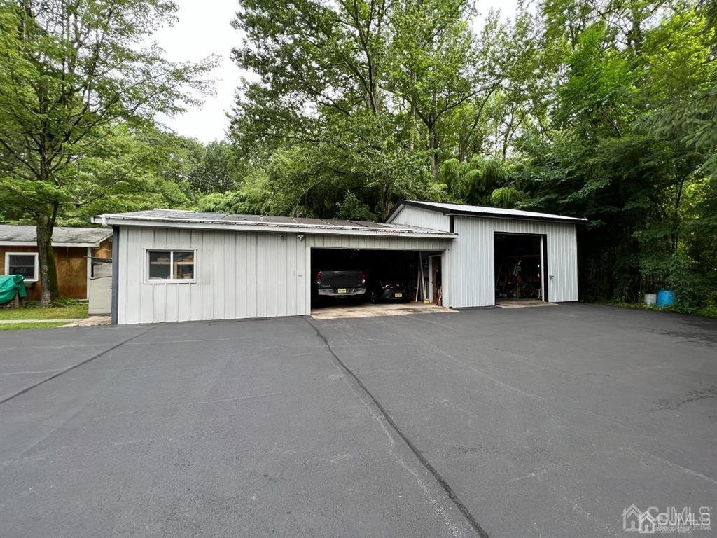 21 White Pine Road North Brunswick, NJ 08902 - Photo 32 of 33 a front view of a house with a yard and garage
