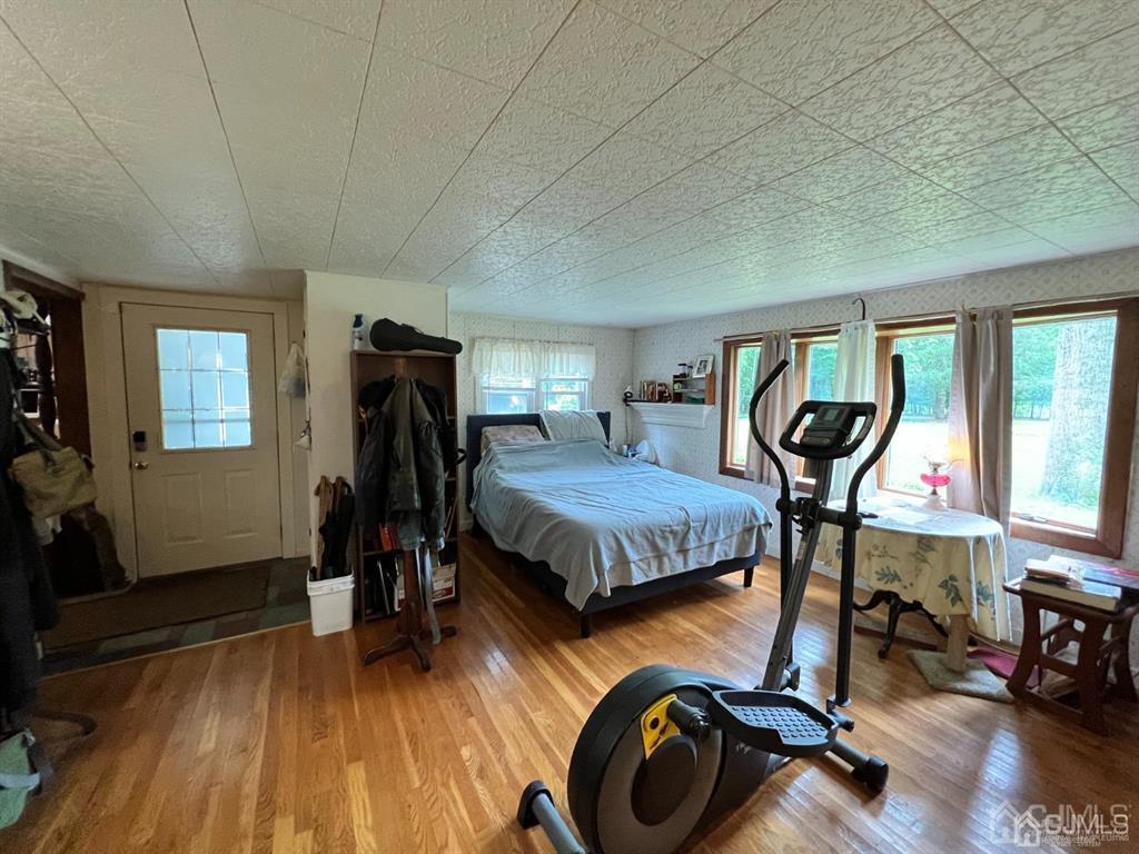 21 White Pine Road North Brunswick, NJ 08902 - Photo 4 of 33 a bedroom with furniture and a gym cycle