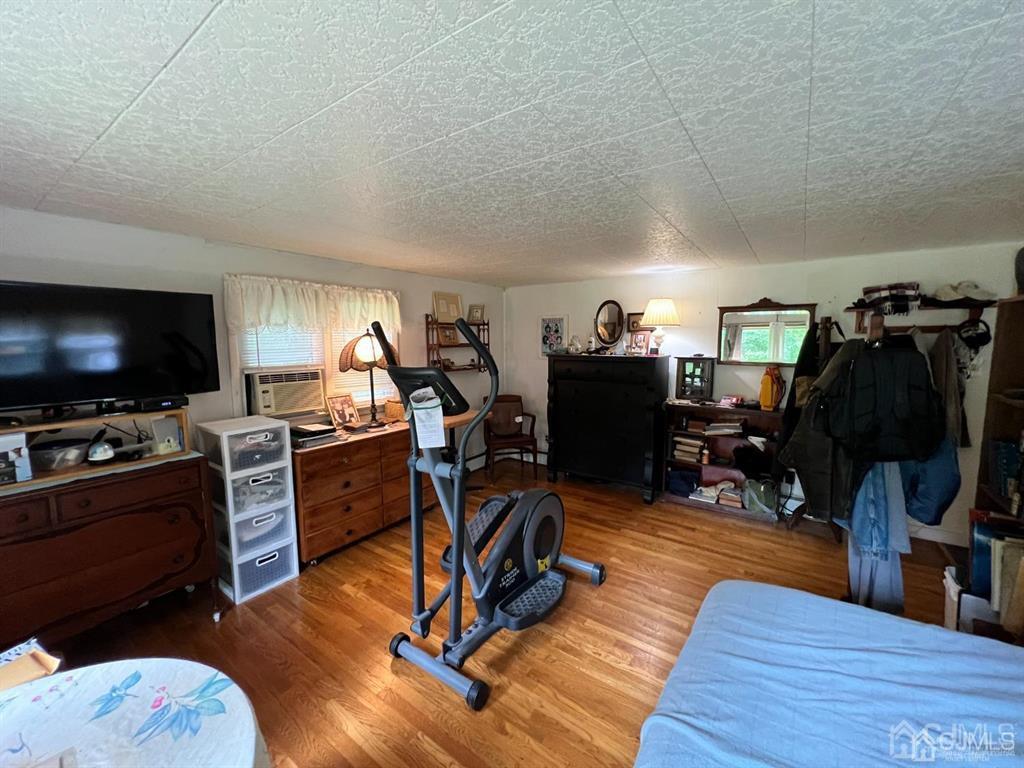 21 White Pine Road North Brunswick, NJ 08902 - Photo 5 of 33 a view of a workspace with furniture and a flat screen tv
