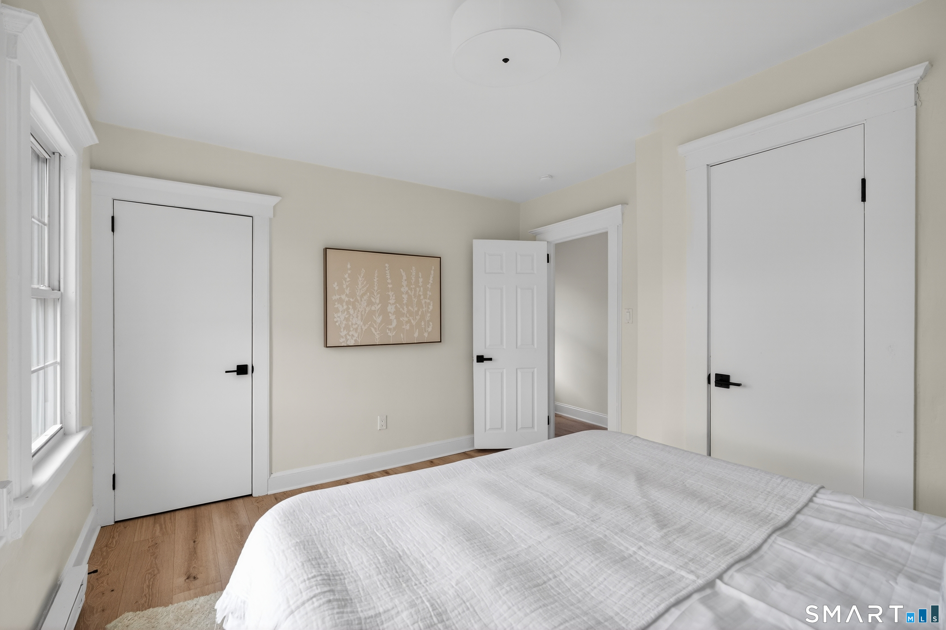 190 West Main Street Milford, CT 06460 - Photo 23 of 28 a view of a bedroom with a bed and wooden floor