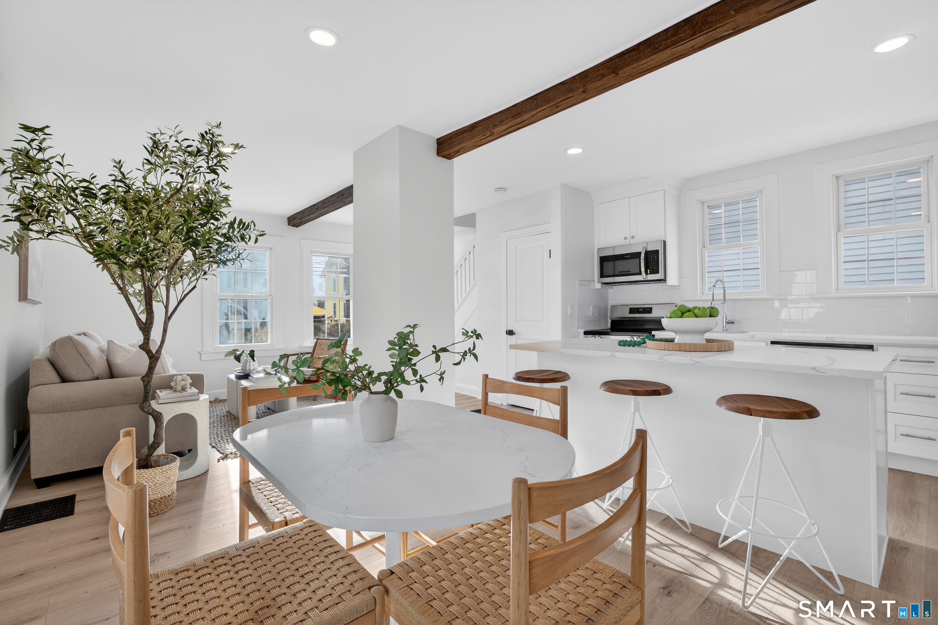 190 West Main Street Milford, CT 06460 - Photo 9 of 28 a dining room with furniture a rug and a kitchen view