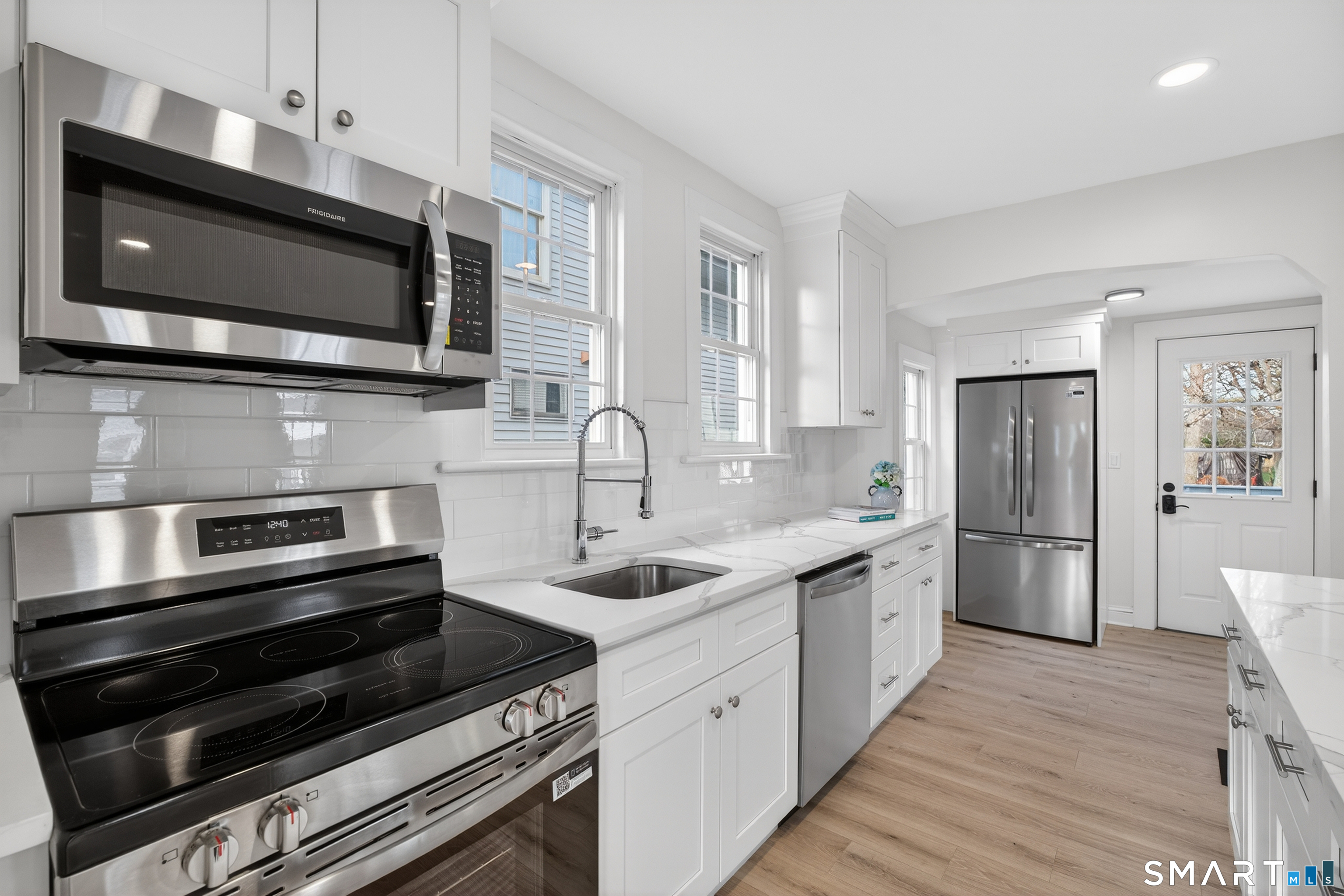 190 West Main Street Milford, CT 06460 - Photo 10 of 28 a kitchen with stainless steel appliances a stove microwave and sink
