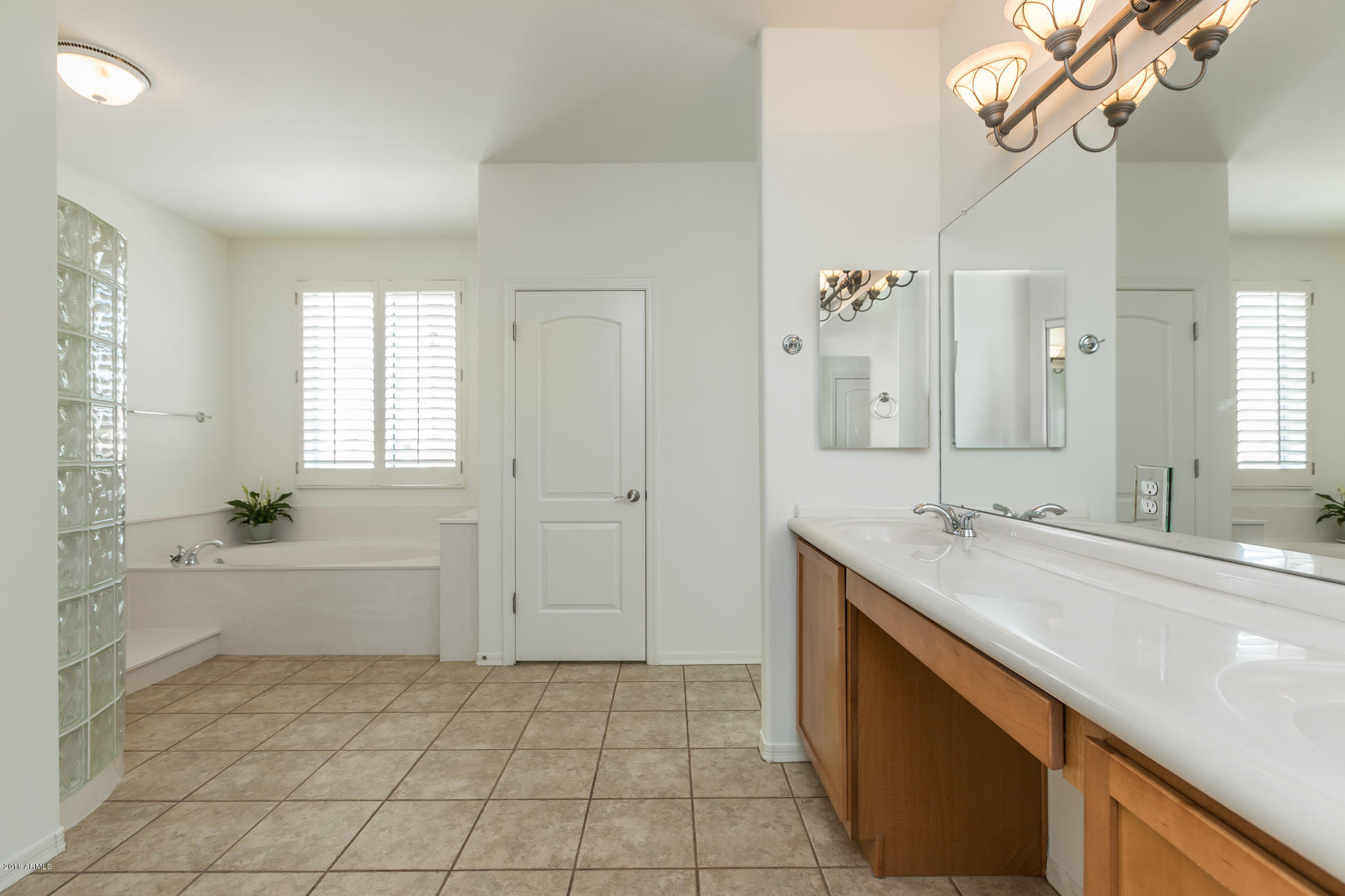 1750 East Ocotillo Road, Unit 23 Phoenix, AZ 85016 - Photo 13 of 27 a spacious bathroom with a granite countertop sink a mirror and a bathtub