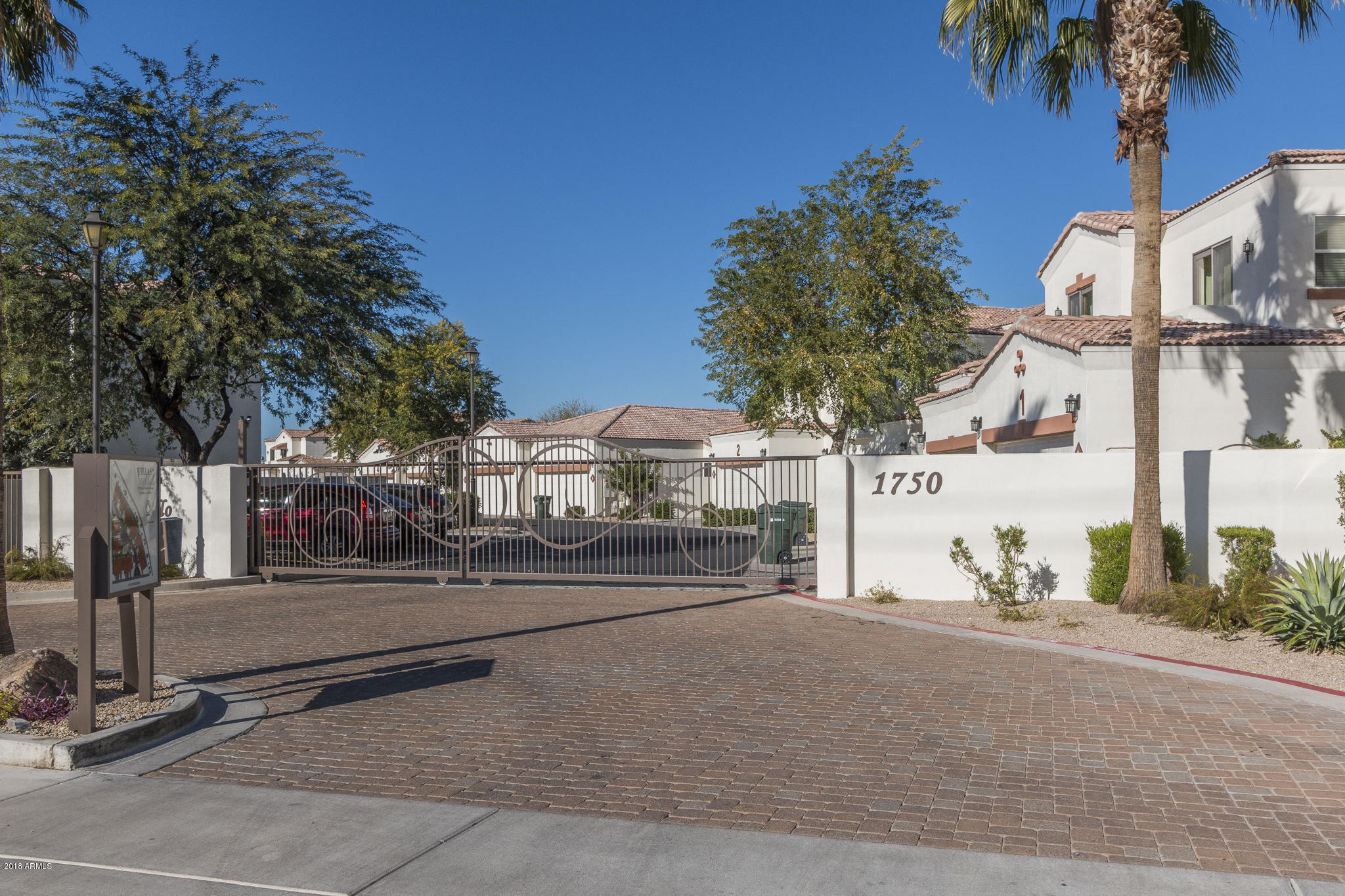 1750 East Ocotillo Road, Unit 23 Phoenix, AZ 85016 - Photo 24 of 27 a street view with tall buildings and a street sign on a wall