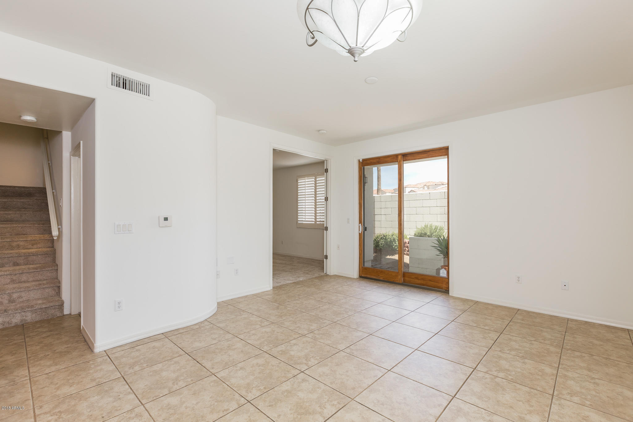 1750 East Ocotillo Road, Unit 23 Phoenix, AZ 85016 - Photo 3 of 27 a view of an empty room with a window