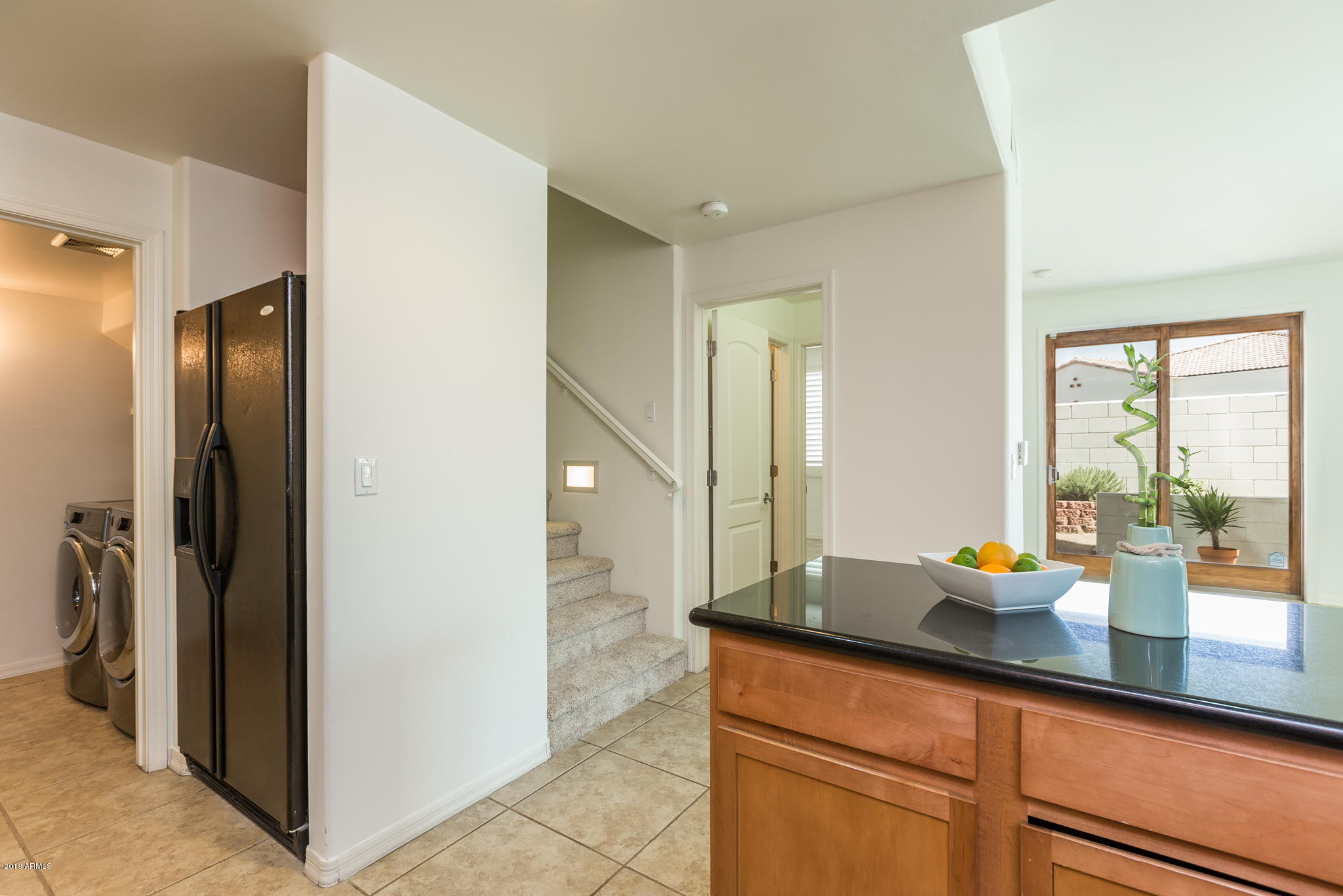 1750 East Ocotillo Road, Unit 23 Phoenix, AZ 85016 - Photo 9 of 27 a kitchen with stainless steel appliances granite countertop a refrigerator and a sink
