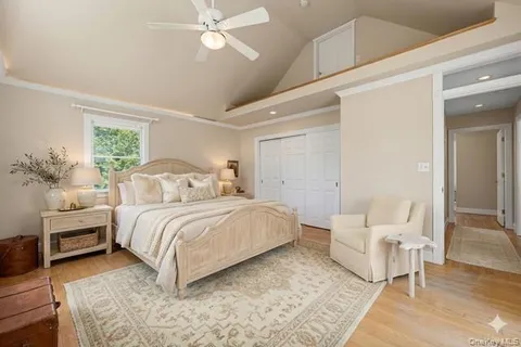a bedroom with a large bed and a chandelier