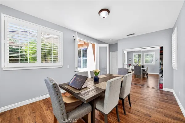 a spacious bedroom with a large bed a chandelier and dresser