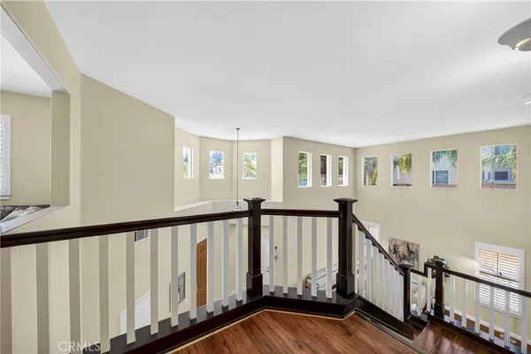 a bedroom with a bed and a window with a chair