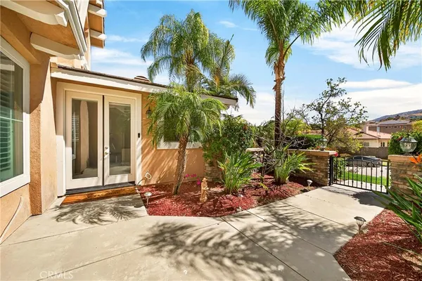 a living room with couches and a dining table with wooden floor