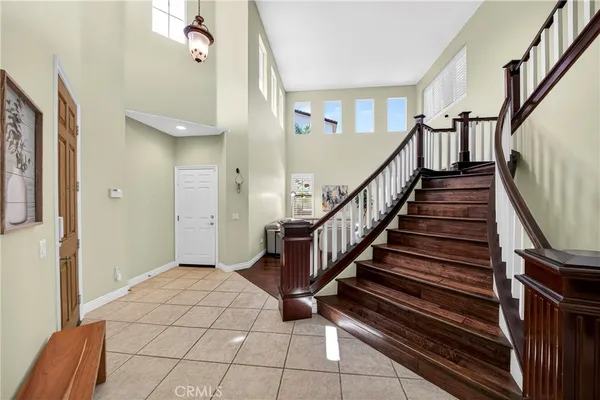 a living room with furniture couches and a dining table with wooden floor
