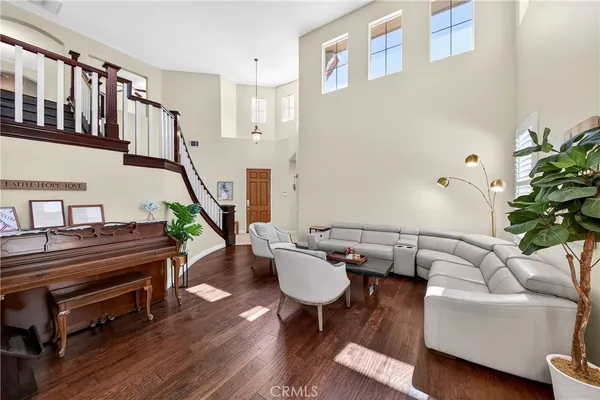a living room with furniture large window and a fireplace