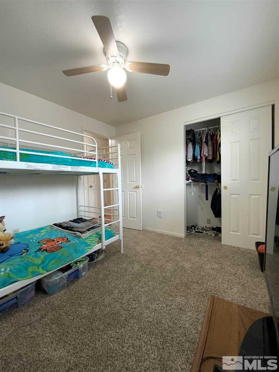 282 River Boat Road Dayton, NV 89403 - Photo 11 of 15 a bedroom with bed and a chandelier